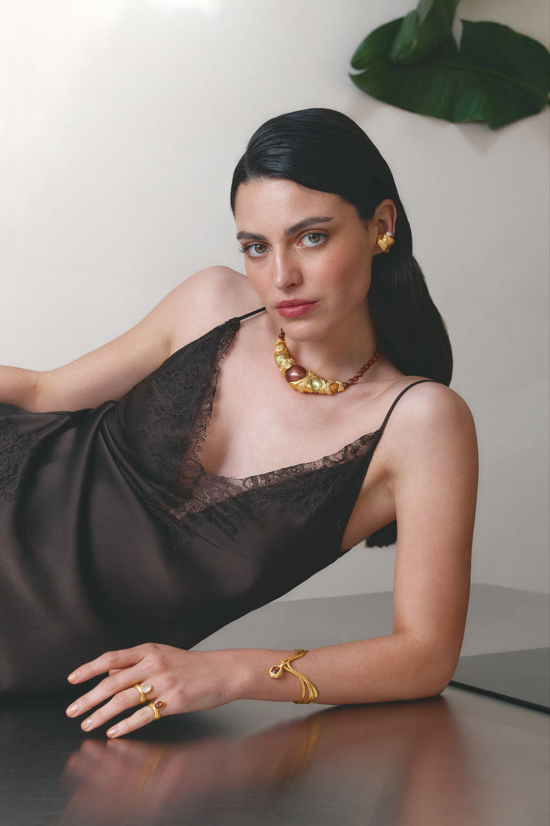 Gold and white drape bracelet by Jude Benhalim featuring elegant, flowing design on a neutral background.