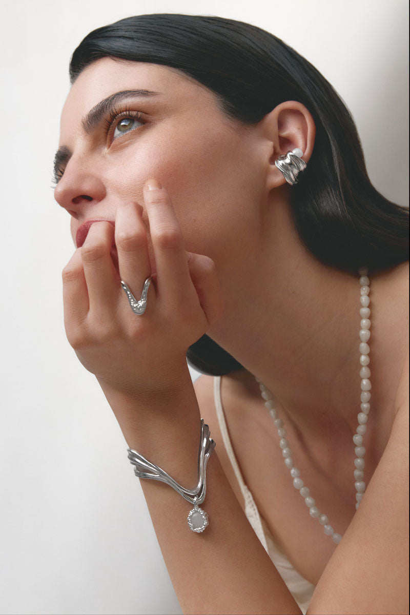 Silver drape ring by Jude Benhalim featuring a sleek, elegant design, shown close-up on a plain background.