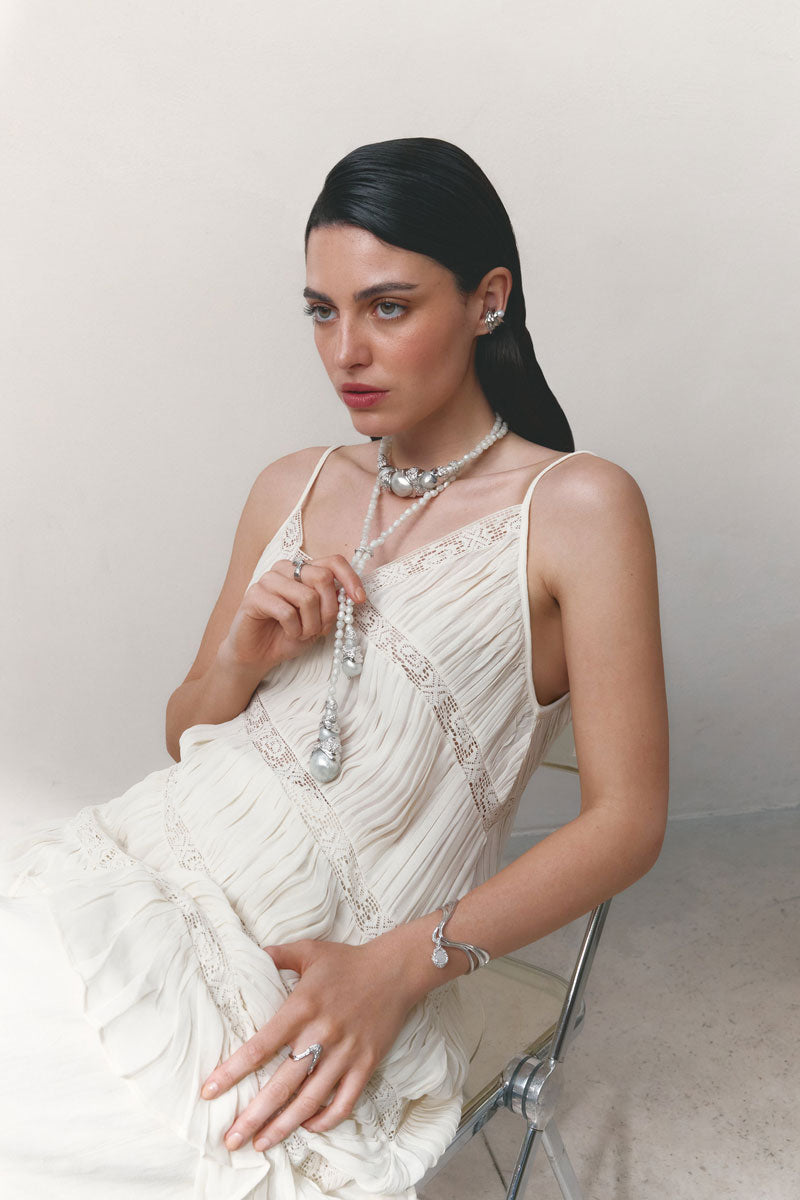 Silver and blue drape bracelet by Jude Benhalim featuring elegant flowing design and intricate details.