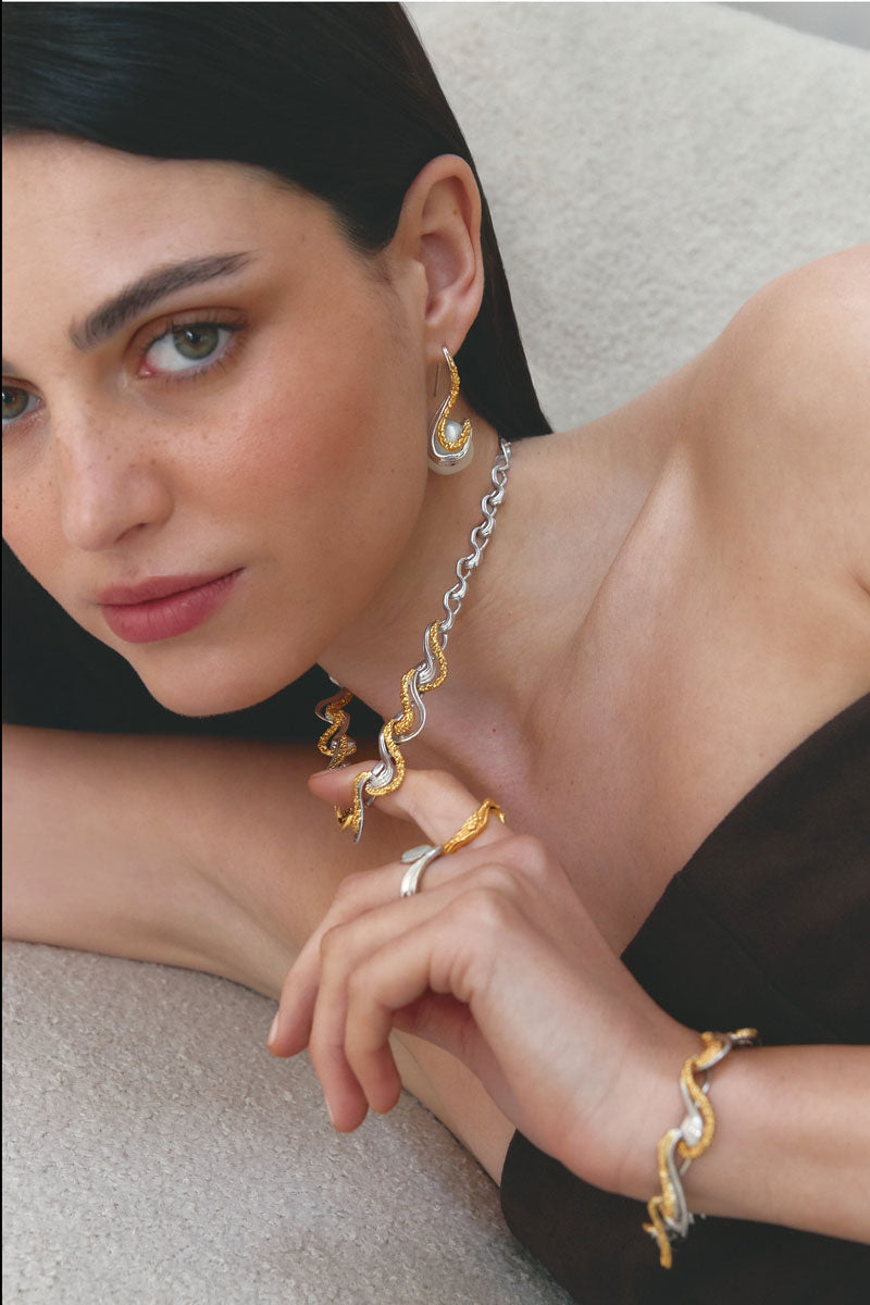 Jude Benhalim ETERNITY earrings featuring elegant, intricate design with silver finish, displayed on a neutral background.