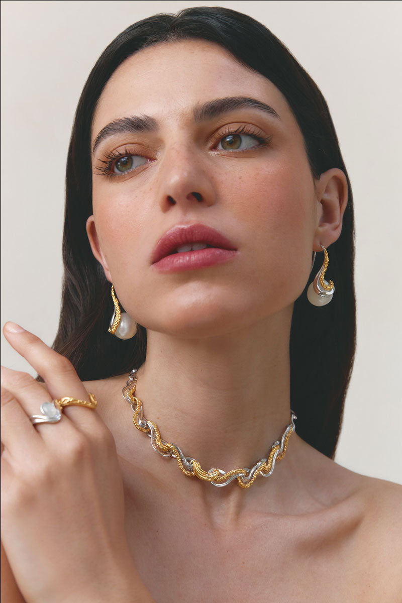 Elegant eternity ring by Jude Benhalim featuring a continuous row of sparkling gemstones on a sleek band.