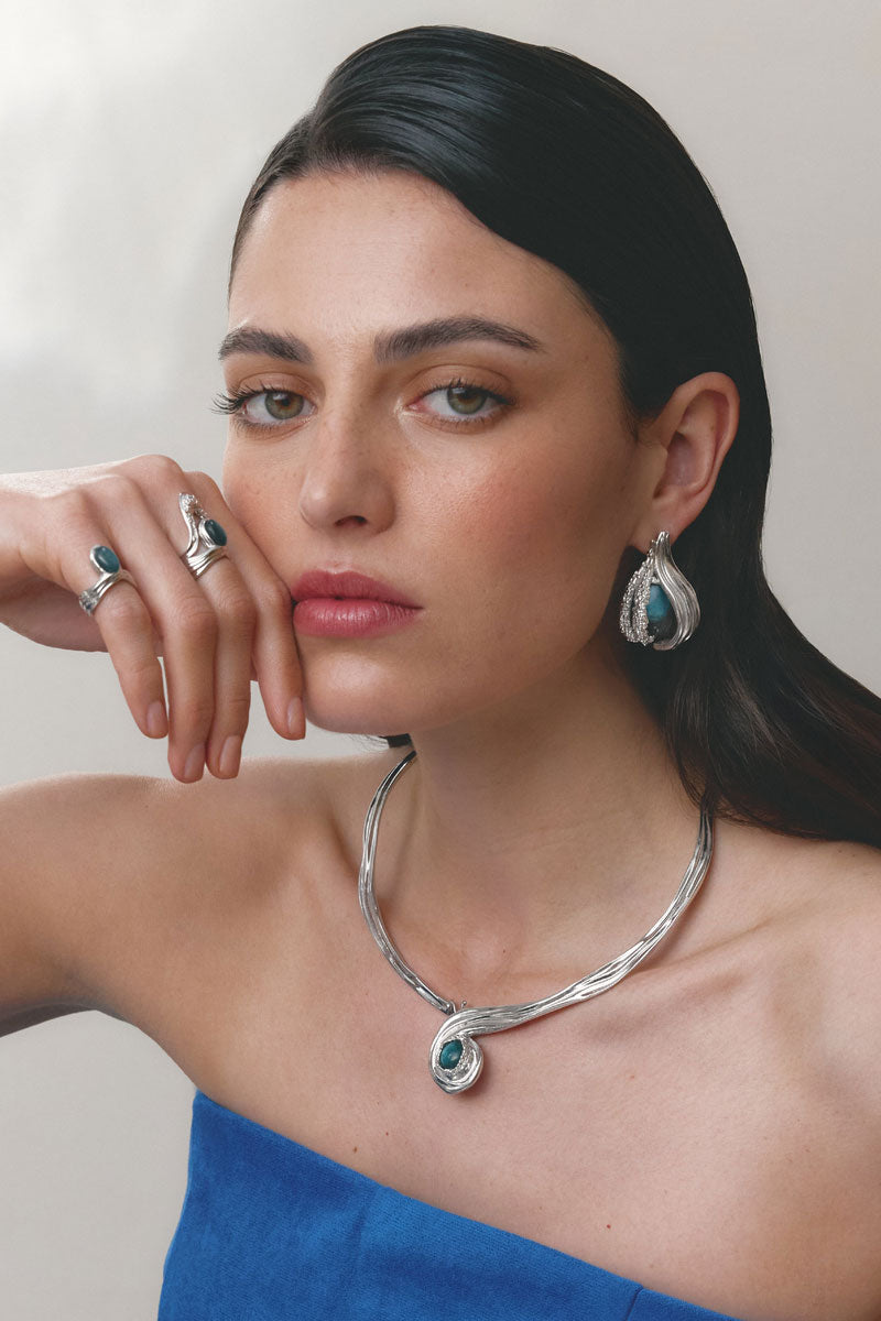 Silver and blue anchor ring by Jude Benhalim, featuring a sleek design with a detailed anchor motif on a polished band.