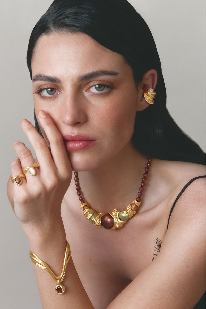 Gold and white anchor ring by Jude Benhalim, featuring a sleek design and nautical-inspired style, shown on a white background.