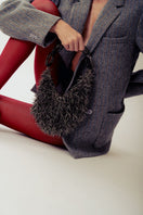 Gray punk-inspired metallic top handle bag from Millanne Tale with a bold, edgy design and sturdy handle.