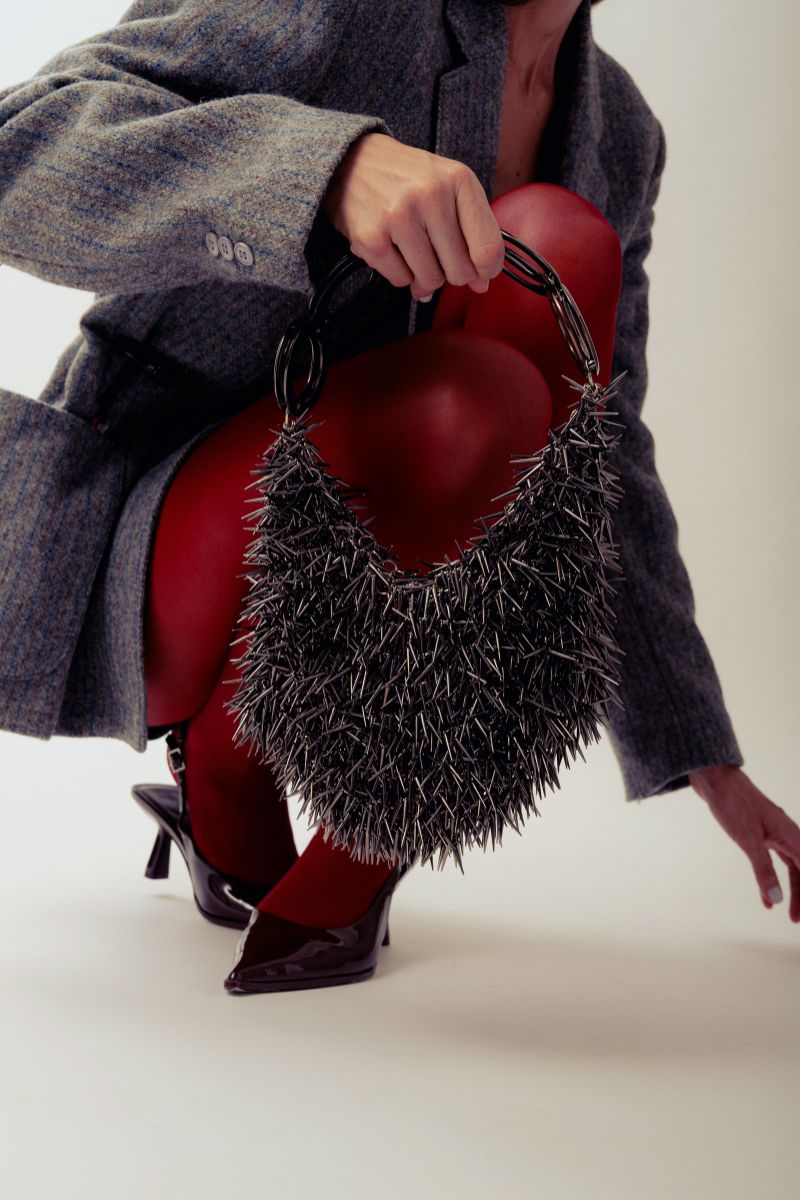 Millanne Tale PUNKA silver top handle bag with metallic finish and modern design, featuring a sleek, structured silhouette.