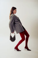 Gray metallic punk-inspired top handle bag by Millanne Tale with silver hardware and a bold, edgy design.