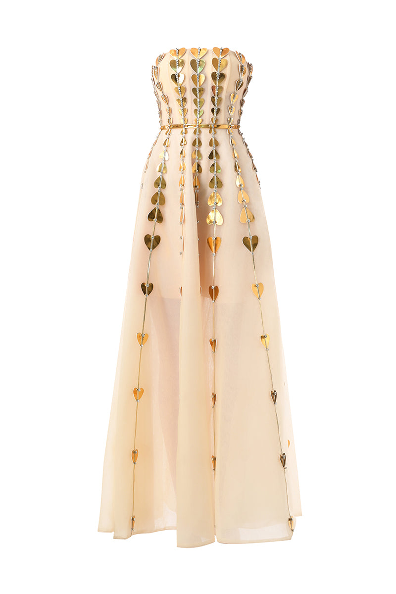 Elegant champagne metallic gown with heart-shaped embellishments by Happy Clothing, featuring a flowing design and intricate detailing.