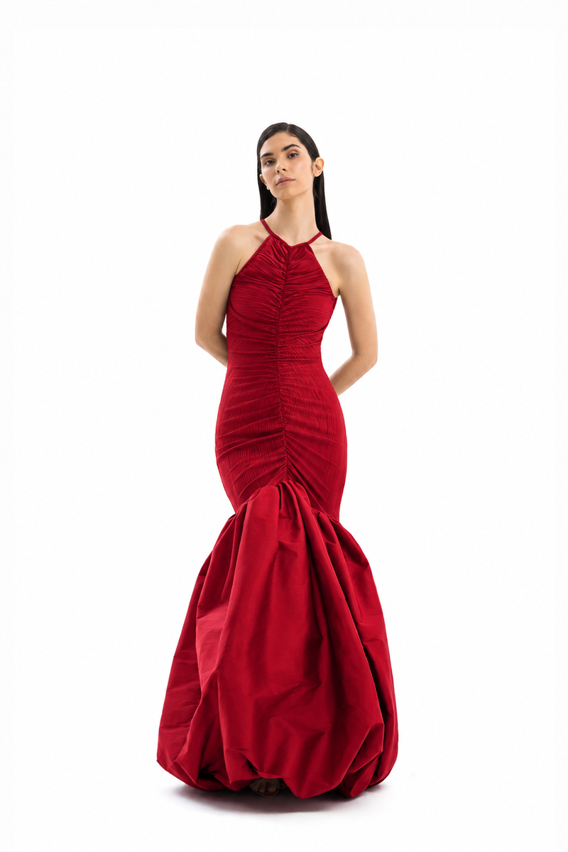Red Mencia gown by Maylé Vásquez, with elegant design, flowing fabric, and detailed neckline, perfect for formal occasions.