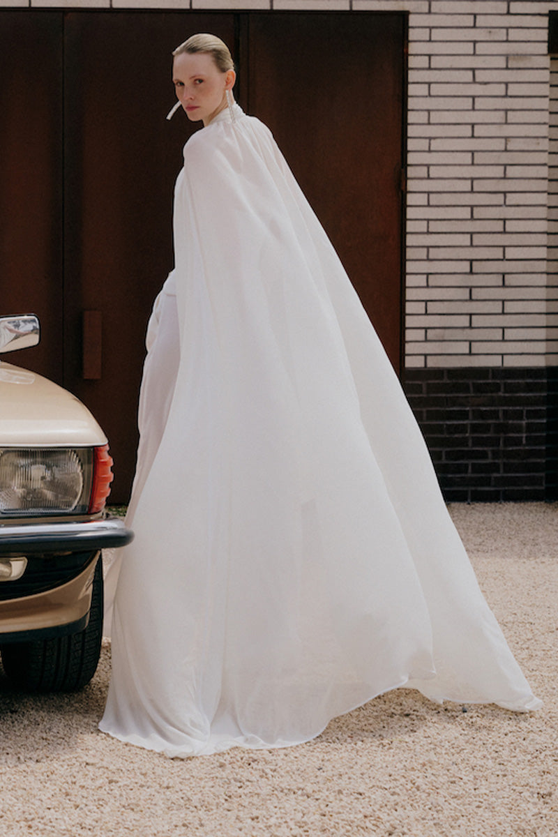 White Reine Cape jacket by Gigii's, featuring a stylish and cozy outerwear design with a flowing silhouette.