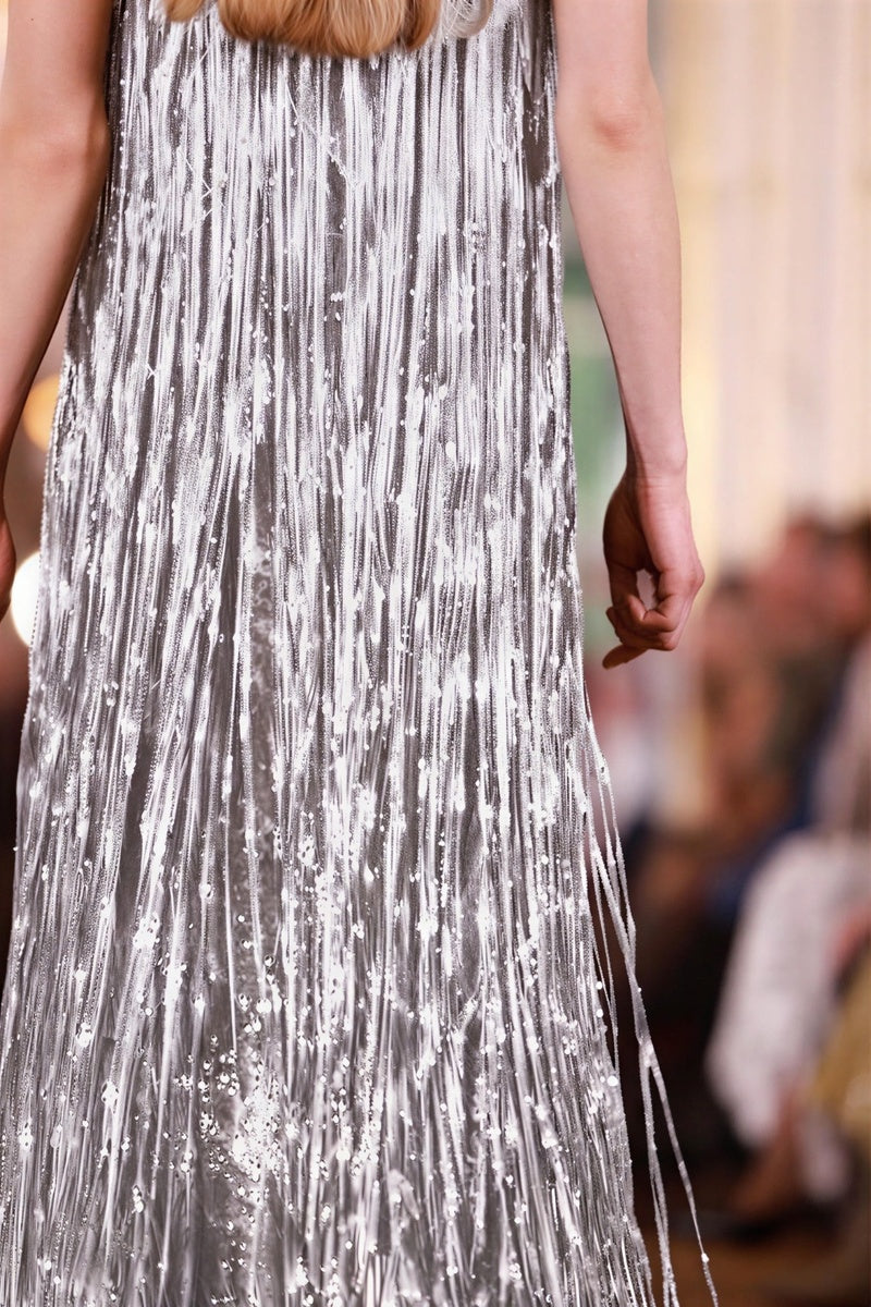 Alersundi Cult Mia X Alersundi Melissa silver gown with flowing fabric and elegant design, shown on a model.