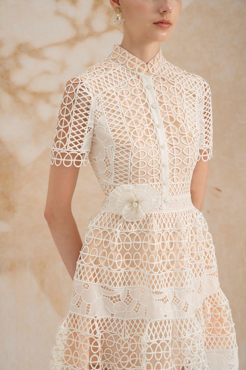 Rosee de Matin Yasmine A-line short-sleeved lace midi dress displayed on a model, showcasing elegant design and intricate lace details.