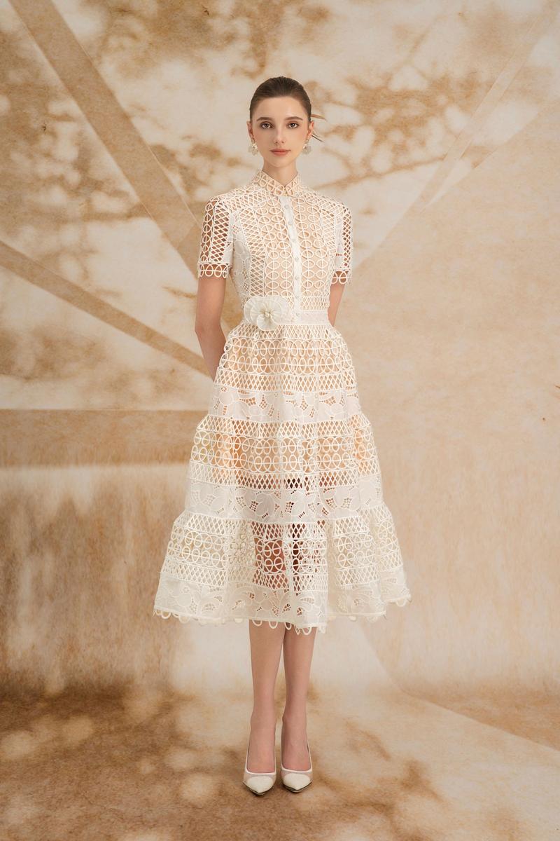 Rosee de Matin Yasmine A-line short-sleeved lace midi dress displayed on a hanger, showcasing its elegant design and intricate lace details.