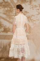 Rosee de Matin Yasmine A-line short-sleeved lace midi dress displayed on a model, showcasing elegant design and intricate lace details.