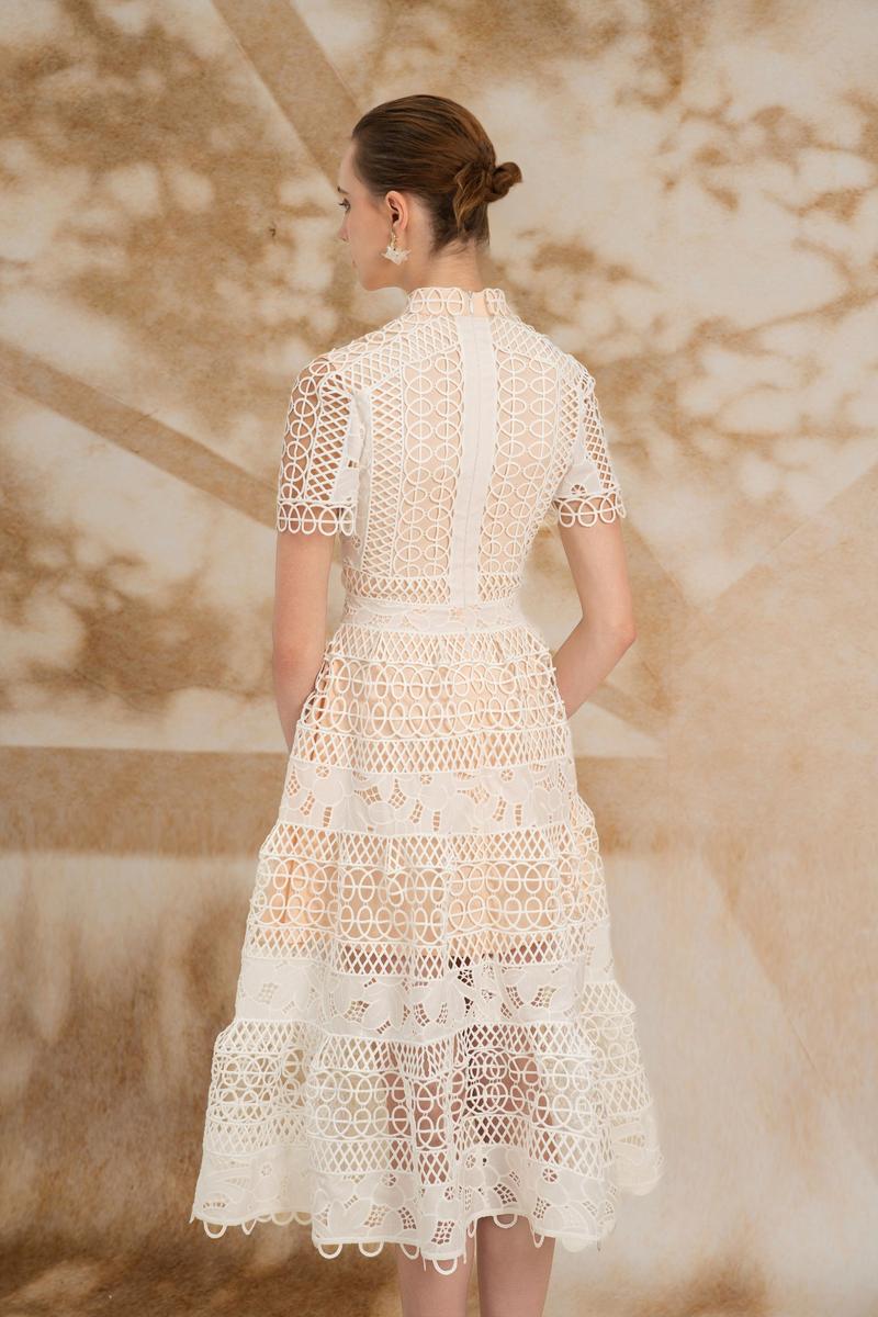 Rosee de Matin Yasmine A-line short-sleeved lace midi dress displayed on a model, showcasing elegant design and intricate lace details.