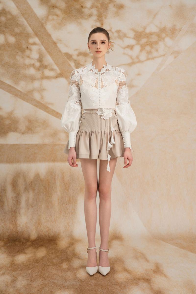 Rosee de Matin Laetitia drop waist puffy sleeve silk lace mini co-ord set on a mannequin.