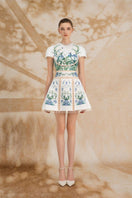 Rosee de Matin Valentina A-line silk satin mini dress with short sleeves, displayed on a mannequin in a stylish setting.