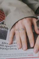 Assorted Riverstone rings from Jude Benhalim, featuring mixed stone designs on a model's hand.
