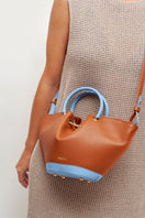 Saonara mini capazo top handle bag in caramel and blue sky with woven design and sturdy handles, ideal for casual carry.