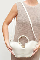 Mini ivory Capazo bag by Saonara featuring a top handle design and woven texture, perfect for casual or elegant outfits.
