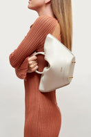Mini ivory Capazo bag by Saonara featuring top handle design and woven texture.