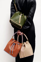 Taupe Peony bucket bag by Saonara, featuring a stylish top handle design and soft peony-colored leather.