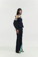 Black embroidered tailored top by Sean Sheila, featuring intricate embroidery and a fitted design, displayed on a black background.