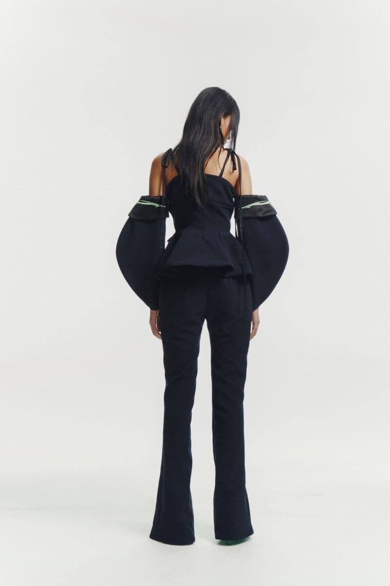Black embroidered tailored top by Sean Sheila, featuring detailed embroidery and a fitted design for stylish office wear.