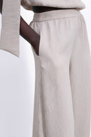 SÉLONE Selis balloon trousers in stone color, featuring a relaxed fit and stylish design, shown on a model.