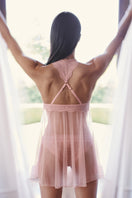 Sheer pink mesh baby doll lingerie by Luciela, featuring delicate fabric and feminine design.