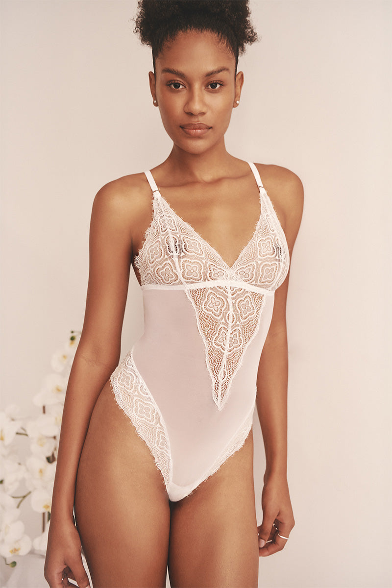 Sheer white mesh bodysuit from Luciela, featuring a sleek design and fitted silhouette, ideal for stylish underwear and layering.
