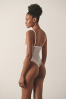 Sheer white mesh bodysuit by Luciela, featuring long sleeves and a fitted design, ideal as stylish underwear or layering piece.
