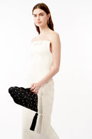 Black wicker Shellona shell-shaped evening clutch bag by Emm Kuo, featuring a stylish shell design and compact size for elegant occasions.