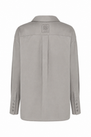 TAGG logo embroidered oversized shirt with high cuffs, showcasing a relaxed fit and detailed embroidery on the front.