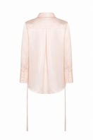 Light blue embroidered TAGG oversized shirt with floral patterns and relaxed fit, shown on a wooden hanger.
