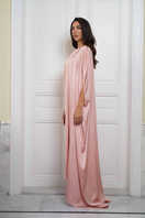 Joanna Andraos Cult Mia X Joanna Andraos soft nude silk gown shown from the side, featuring flowing fabric and elegant design.