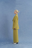 JINSUN double-breasted green wool jacket shown from a side angle, featuring classic lapels and tailored fit.