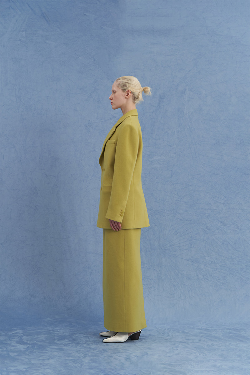 JINSUN double-breasted green wool jacket shown from a side angle, featuring classic lapels and tailored fit.