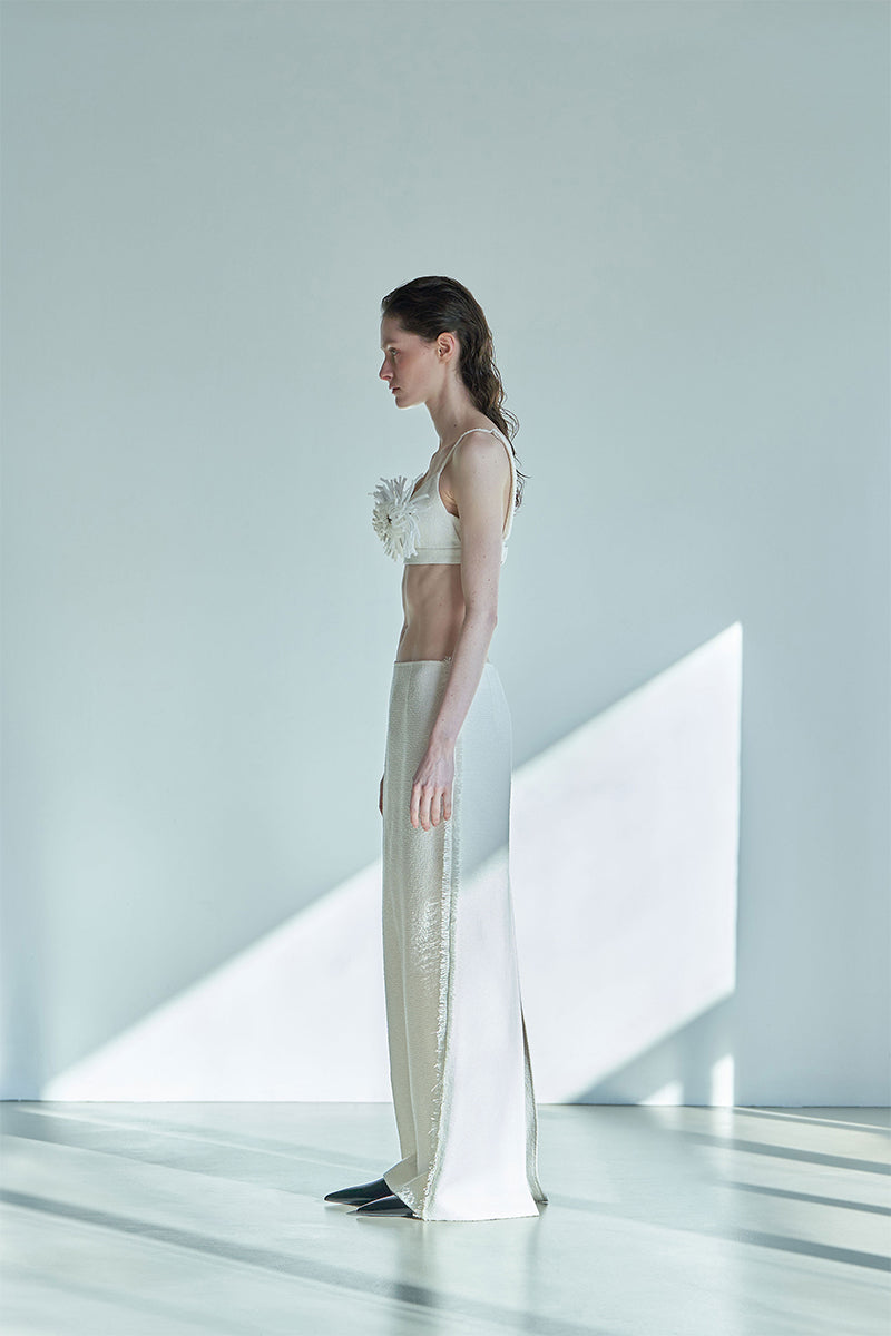 Side view of JINSUN ivory tweed Pappus Applique bra top, showcasing its stylish design and textured fabric.