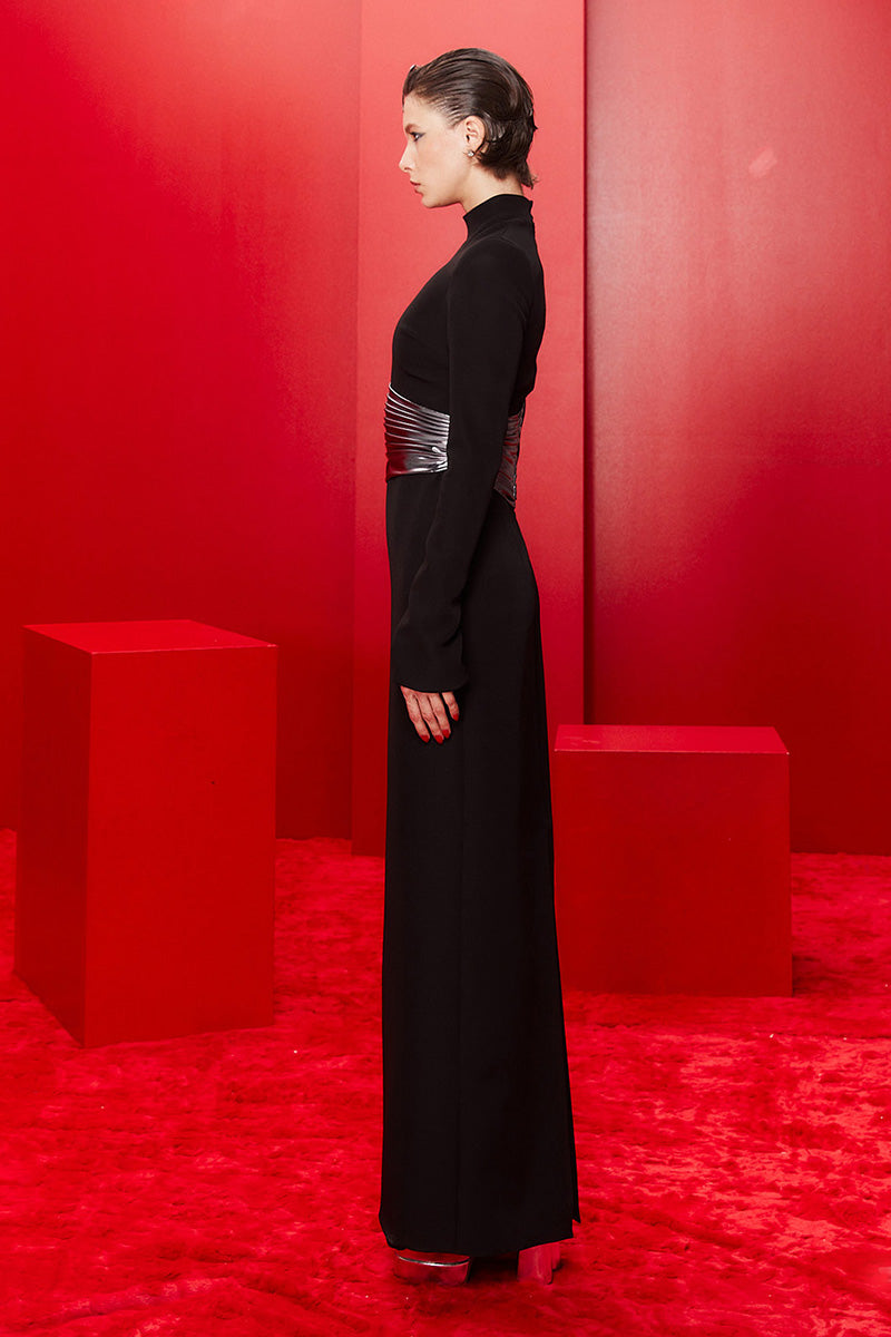 Joanna Andraos midnight black halterneck gown with metallic draped waist, shown from the side view.