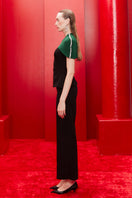 Joanna Andraos midnight black co-ords set with top, pants, and detachable emerald cape, shown from side view.