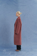 JINSUN oversized pink Suri alpaca coat shown from the side, featuring a plush, cozy design and wide fit for stylish comfort.