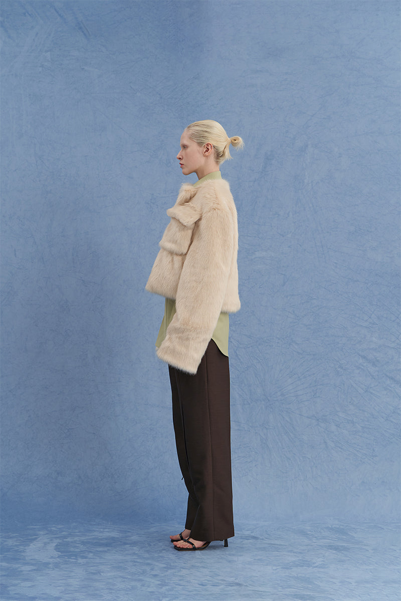 JINSUN beige shearling jacket with exaggerated shoulders, shown in a side view featuring textured collar and cozy design.