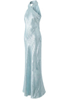 Aisl Celeste Crisscross Maxi Dress in ice blue, shown from the side, featuring a flowing fabric and stylish crisscross design.