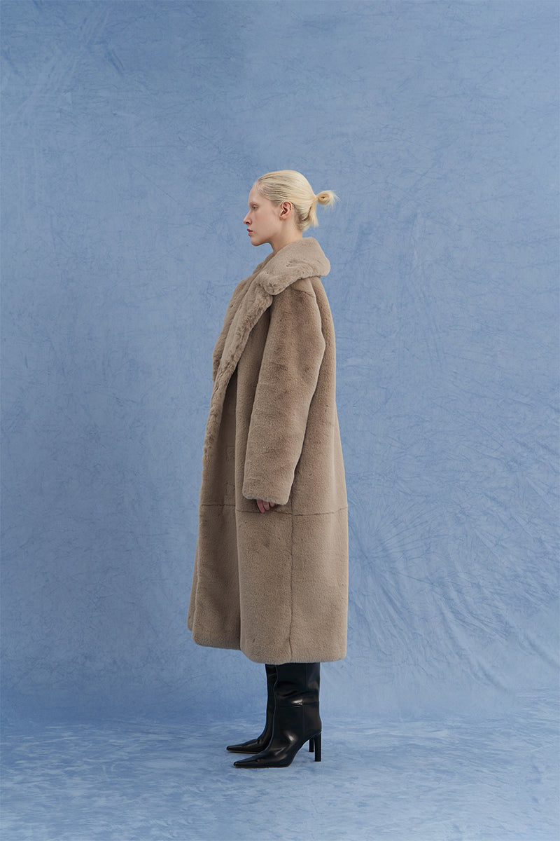 JINSUN oversized shearling coat in brown shown from side view, featuring plush shearling material and relaxed fit.
