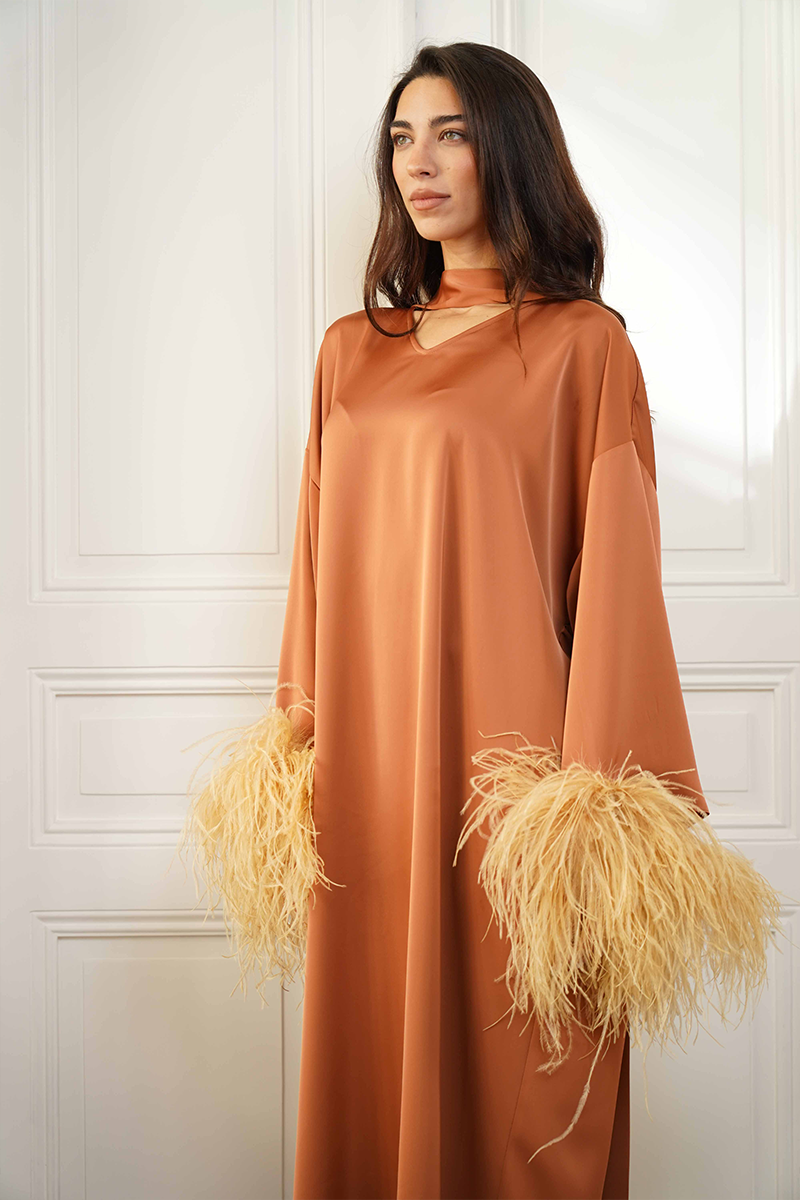 Close-up of the CULT MIA X Joanna Andraos Amber Silk-Effect Gown showing elegant fabric texture and side silhouette detail.