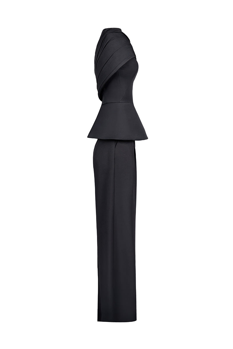Joanna Andraos black crepe two-piece co-ord set with draped cape, shown from side angle on model.