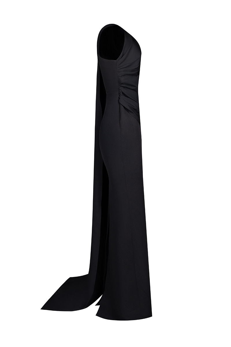 Joanna Andraos Midnight Elegance one-shoulder gown shown from the side, elegant black evening dress with flowing fabric.