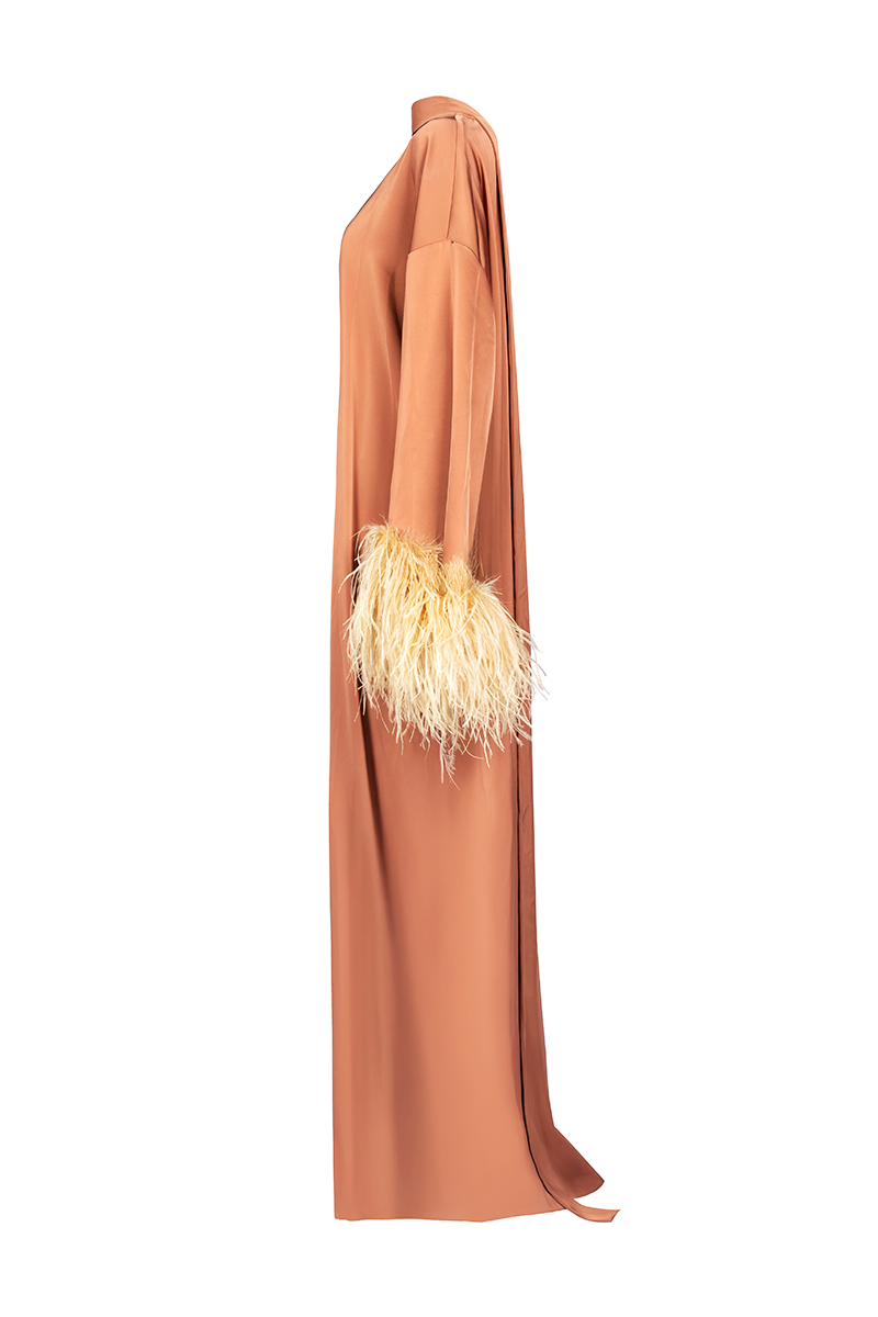 Joanna Andraos CULT MIA X Joanna Andraos amber silk-effect gown shown from the side, flowing elegant design with soft fabric.