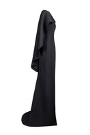 Side view of Joanna Andraos black cascade gown featuring flowing fabric and elegant design for formal occasions.