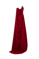 Side view of a red strapless gown by Joanna Andraos, featuring elegant draping and a fitted silhouette.